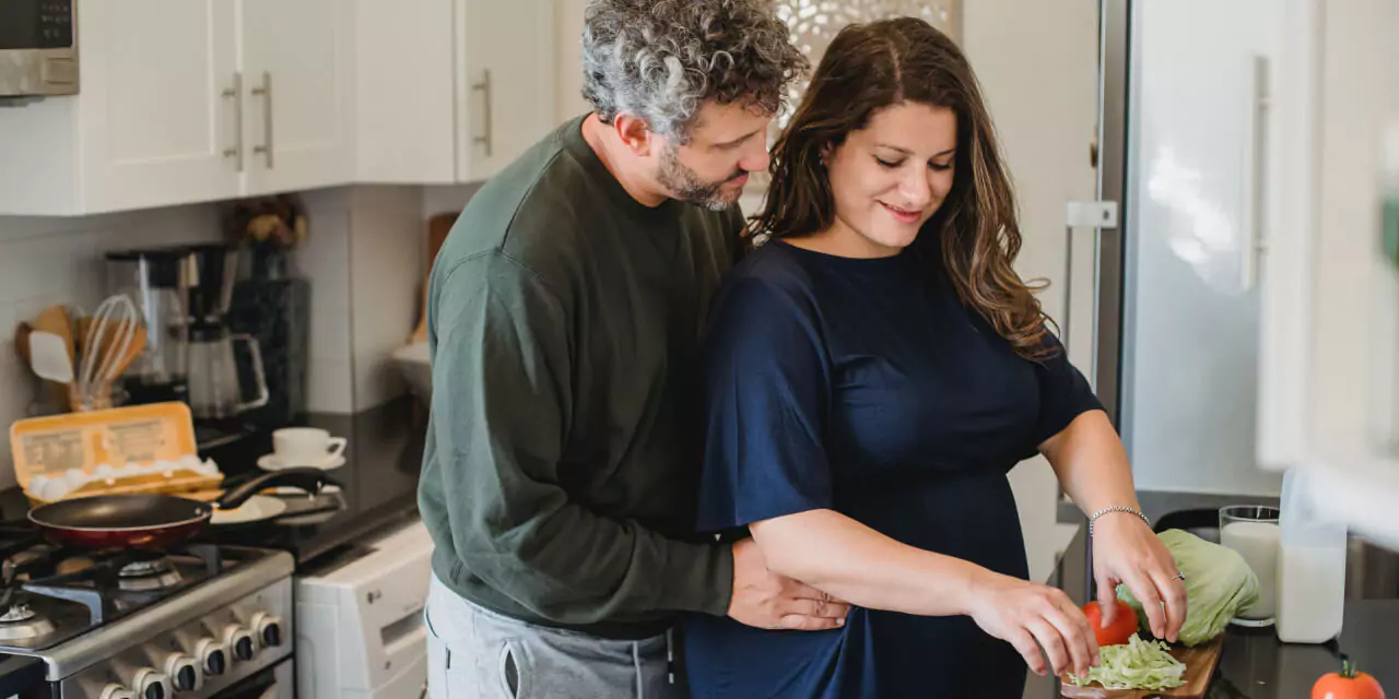 a couple of people making a salad
