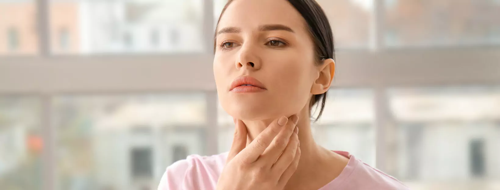 a person examining their neck