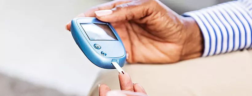a person using finger prick method to test glucose level