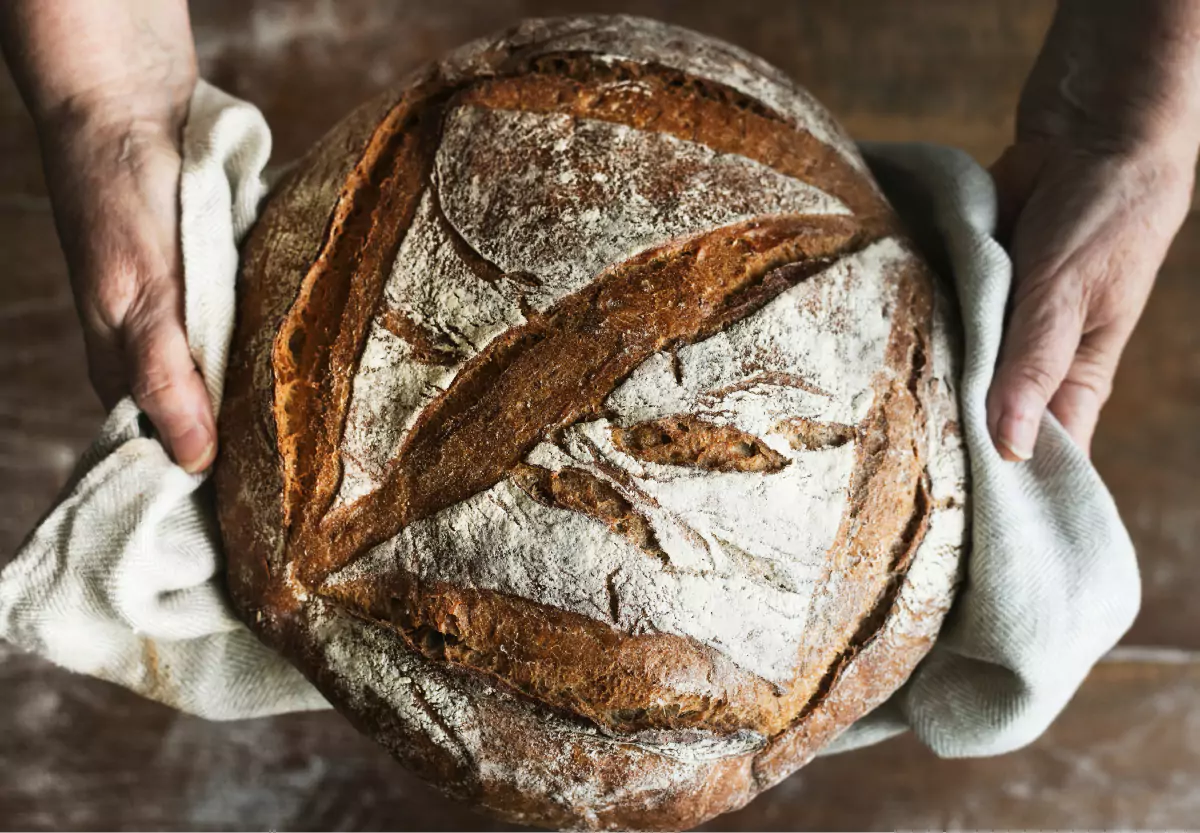 a loaf of whole wheat bread taken out of the oven