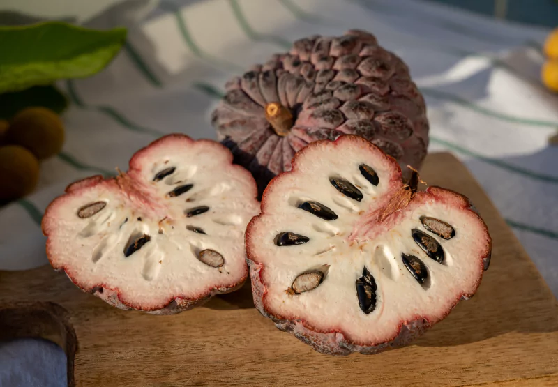 a ripe custard apple cut in half