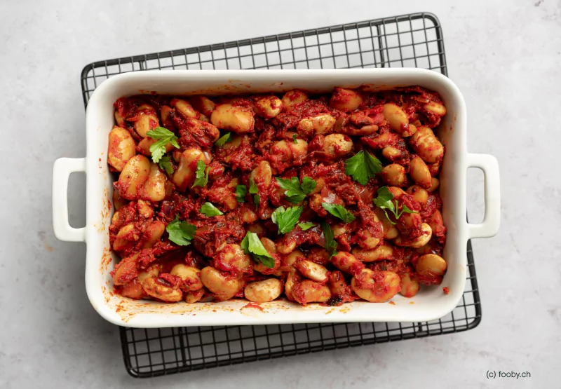 a greek dish with beans and tomato