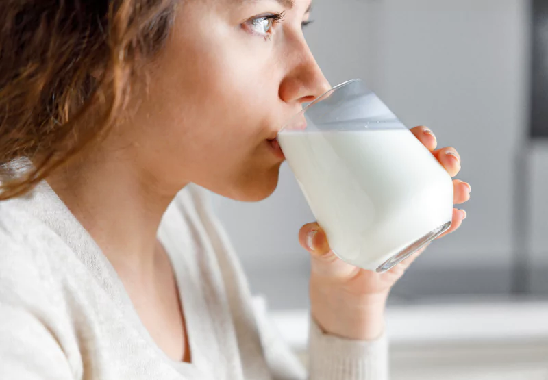 a girl drinking a glass of milk