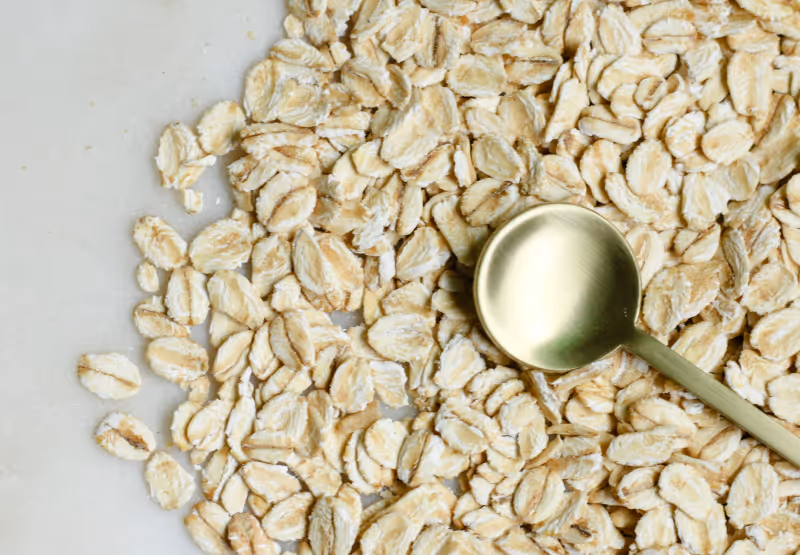 a golden spoon pressing nuts and seeds