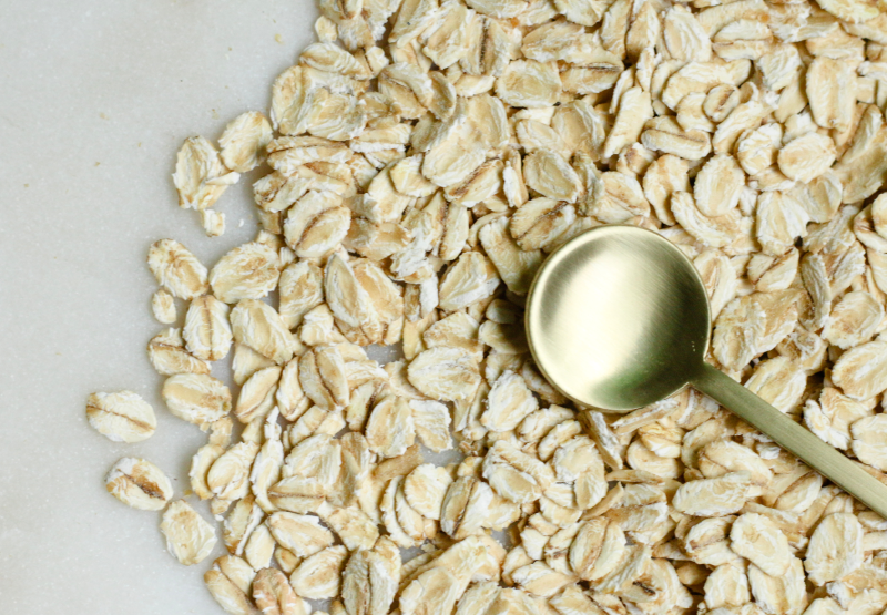 a golden spoon pressing nuts and seeds