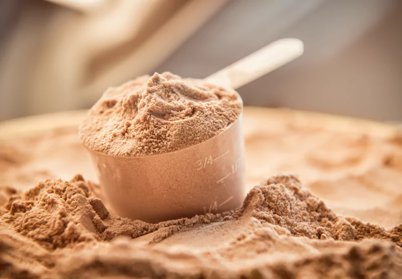 A measuring cup filled with cocoa powder 