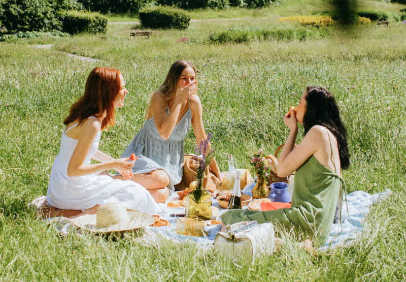 three girls having a picnic in the park