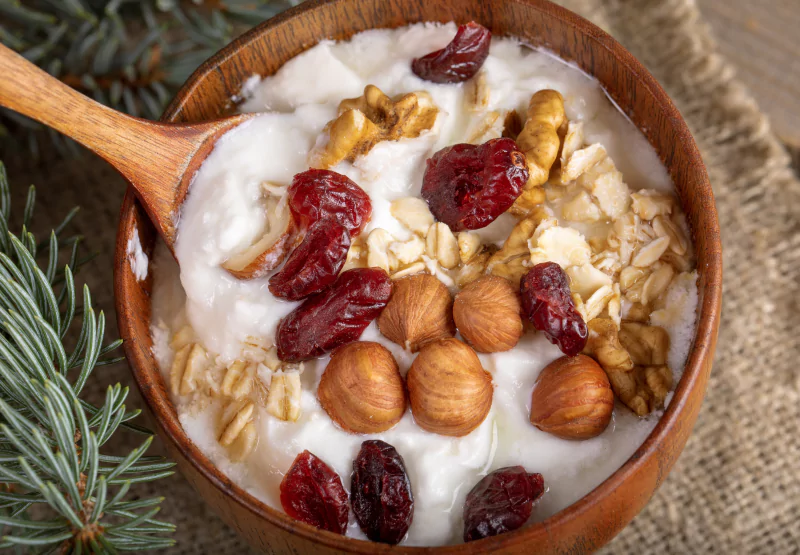 a greek yogurt bwol with oats, nuts, and cranberries