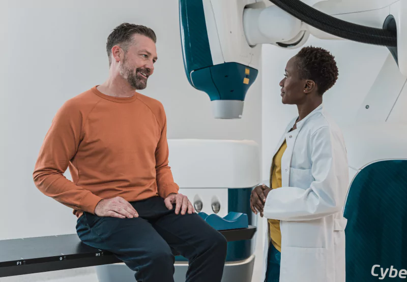 a man at the doctor's office sitting on a table