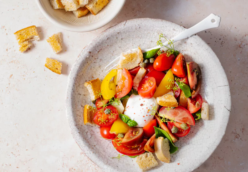 a plate of burrata and tomatoes