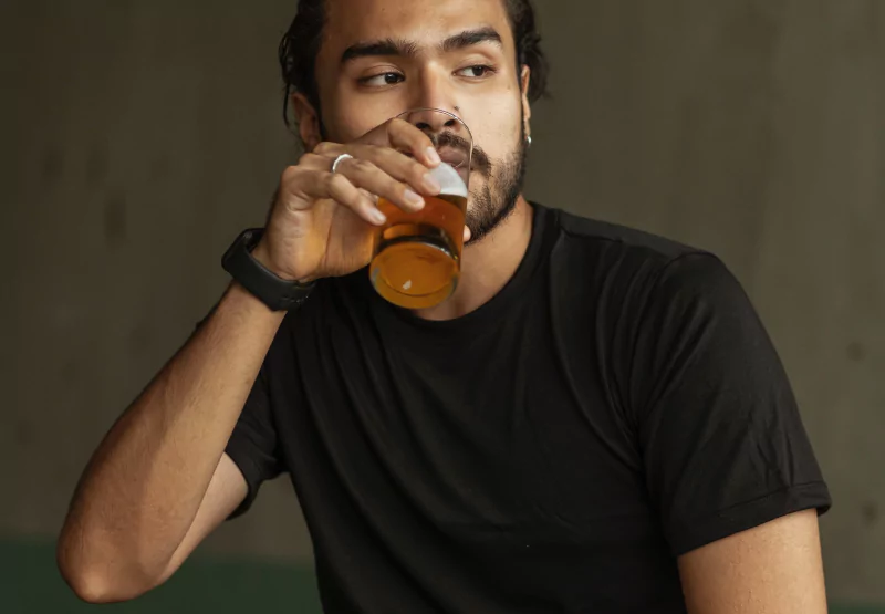 a man drinking a beer