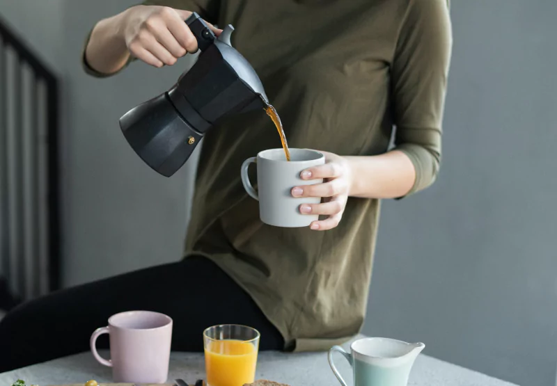 someone pouring a cup of coffee