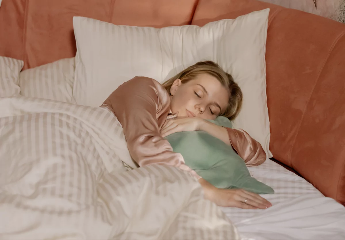 a girl sleeping and holding a pillow