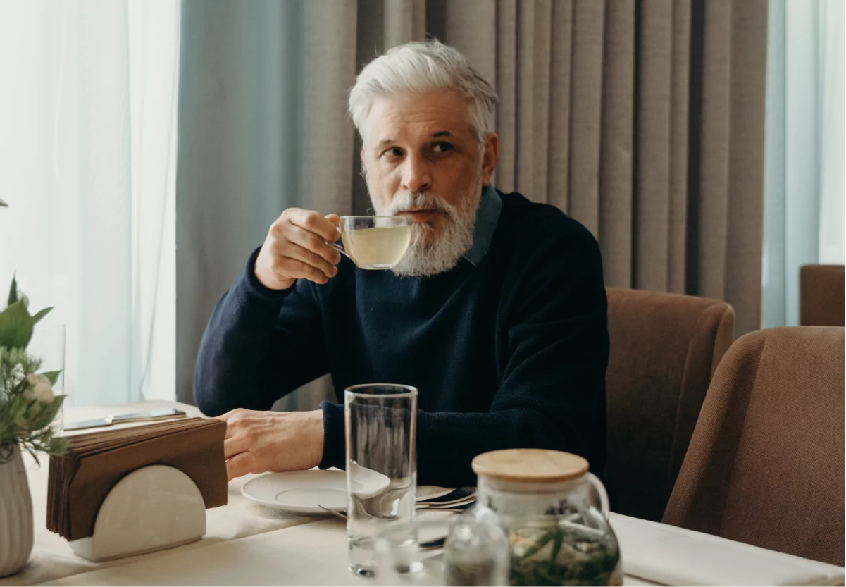 a man sipping a cup of tea