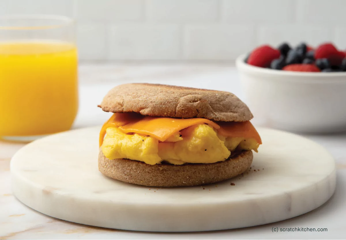 an english muffin with eggs and sausage