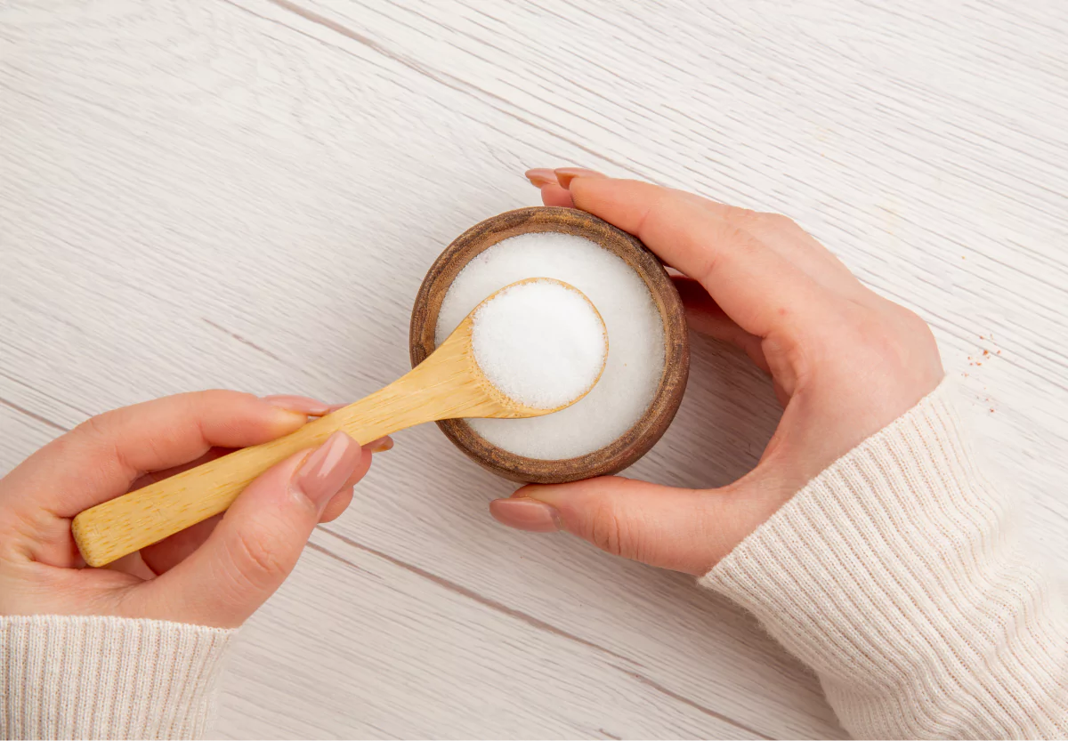 someone holding a spoonful of erythritol