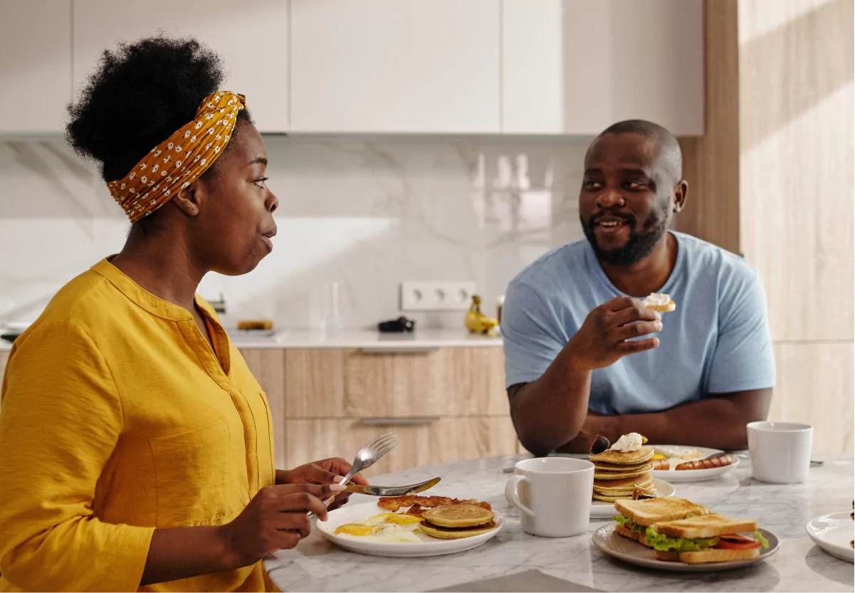 two people eating breakfast together at home