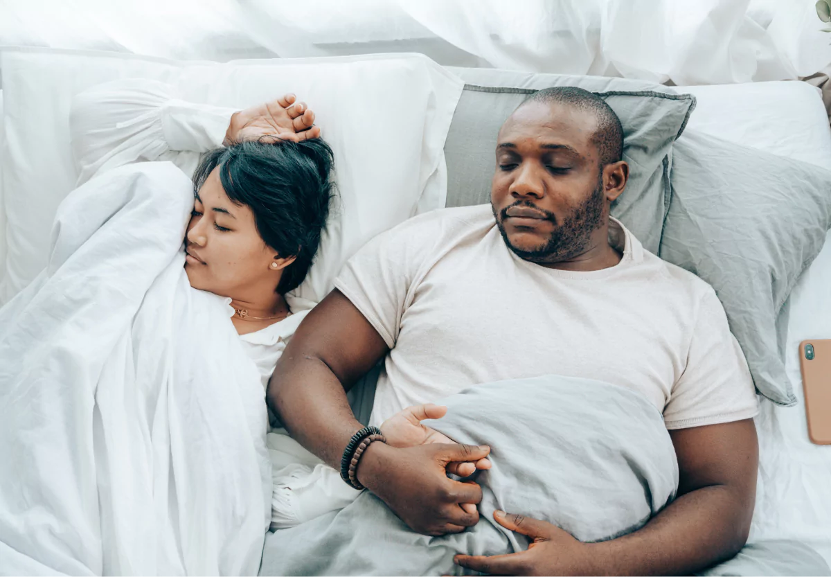 two people sleeping in bed