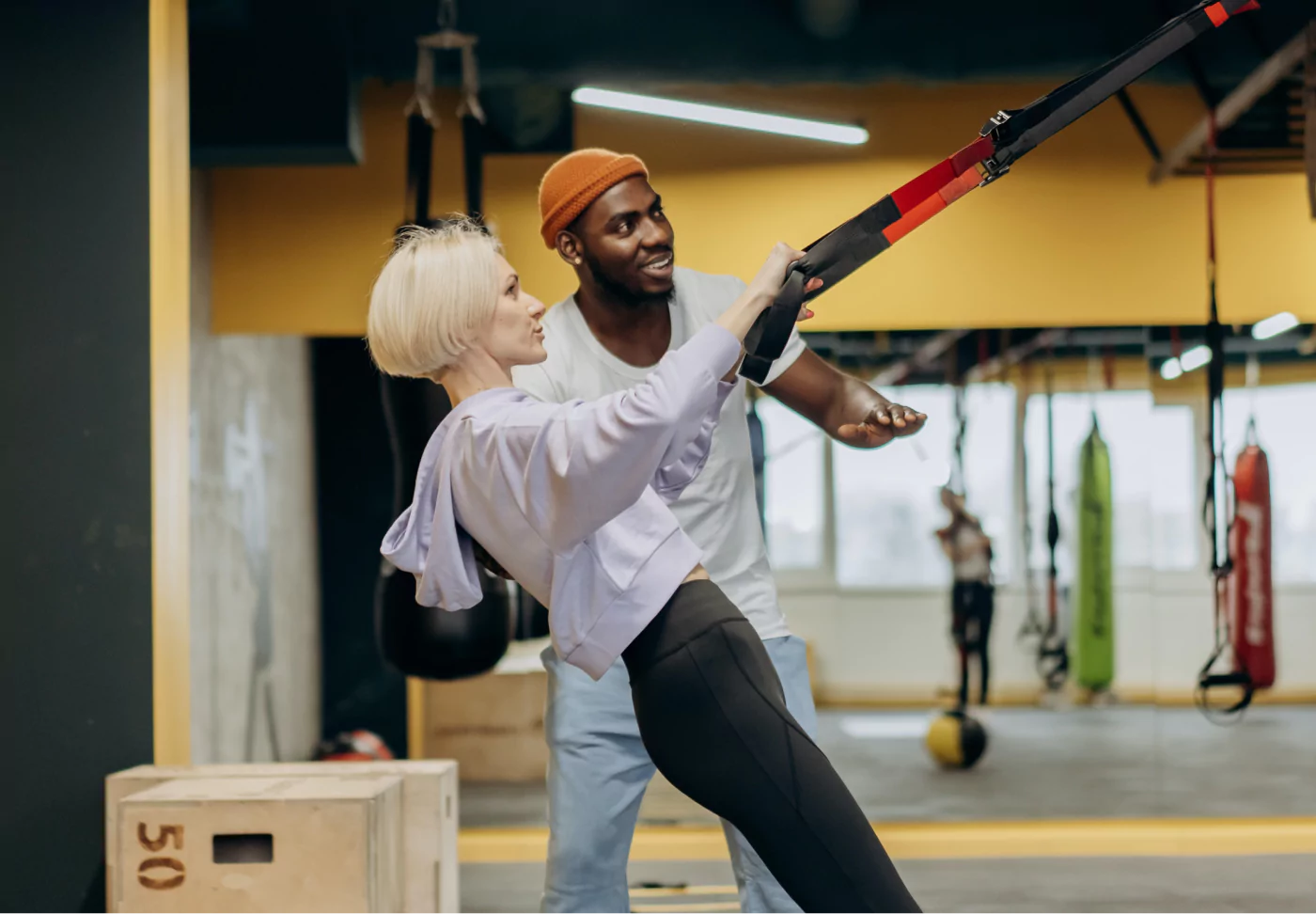 a woman and her trainer doing an exercise at the gym