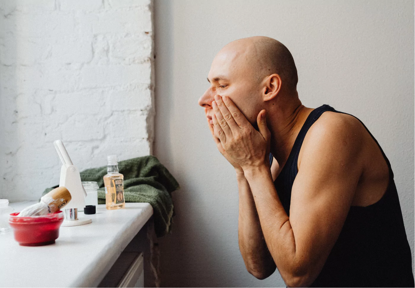 a man putting on aftershave