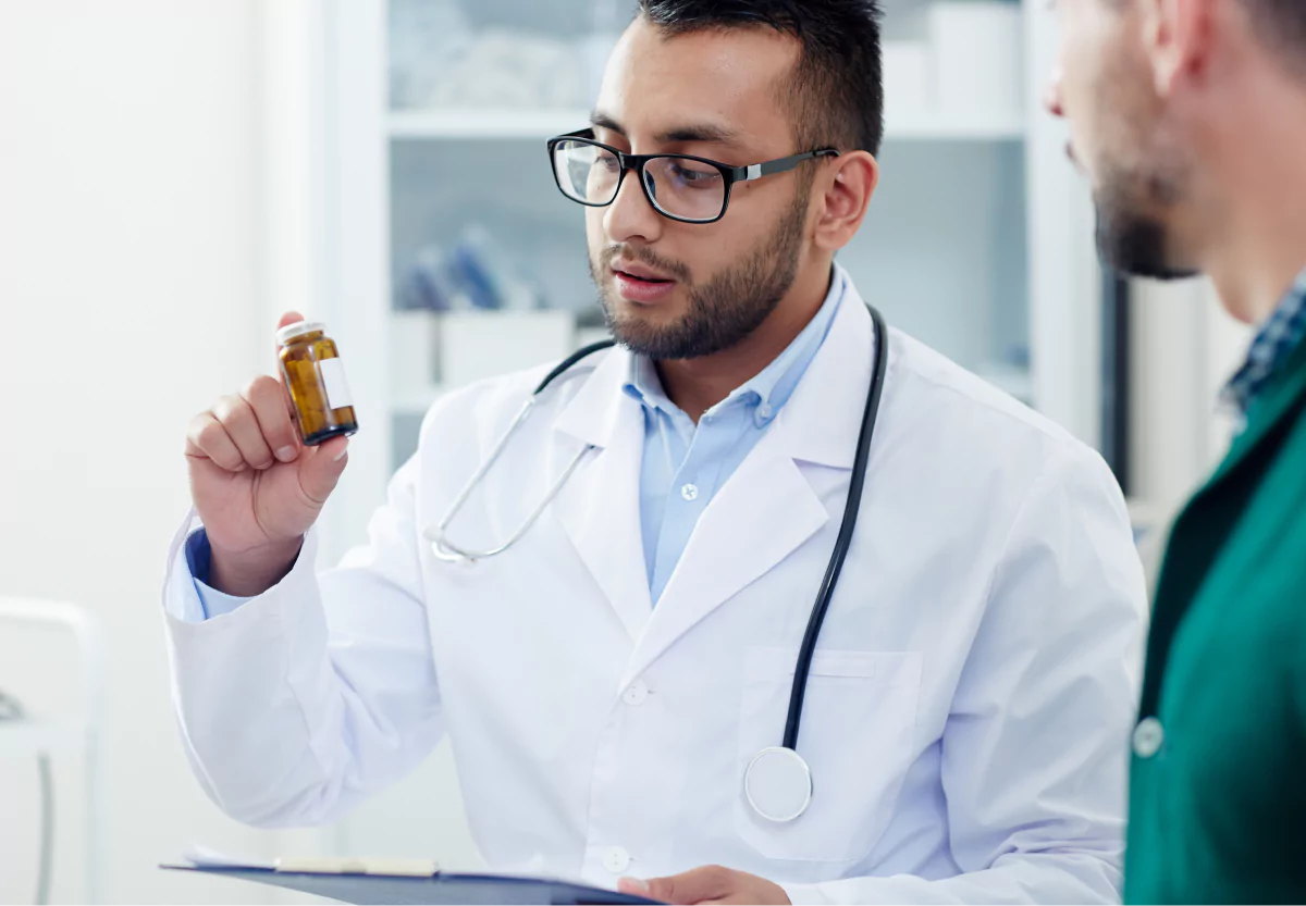 a doctor holding a bottle of cbd