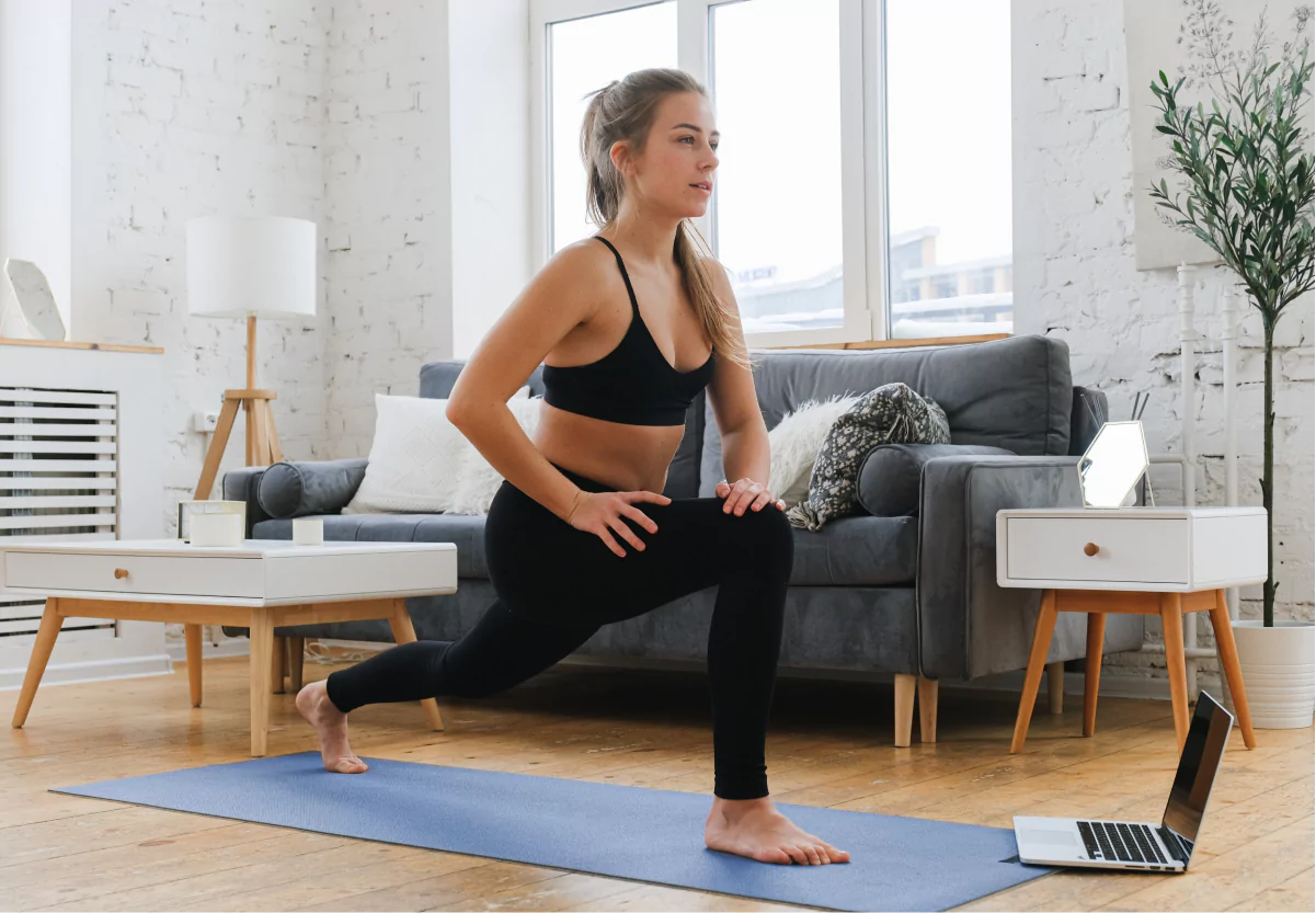 a woman doing a yoga pose at home