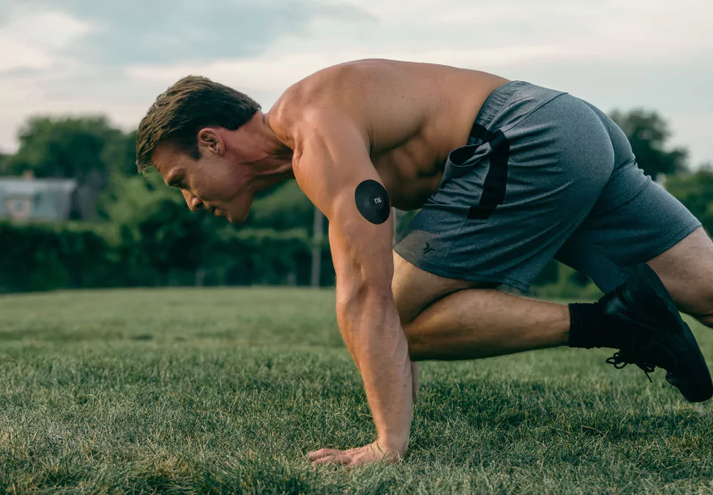 someone with a nutrisense patch doing core exercises