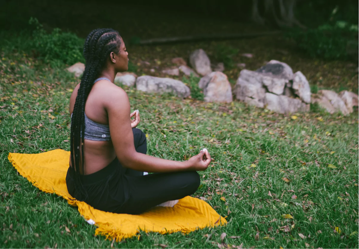 a woman doing yoga in the park