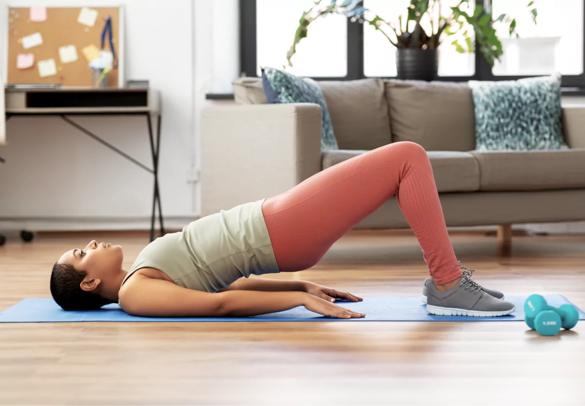 a woman doing glute bridges at home