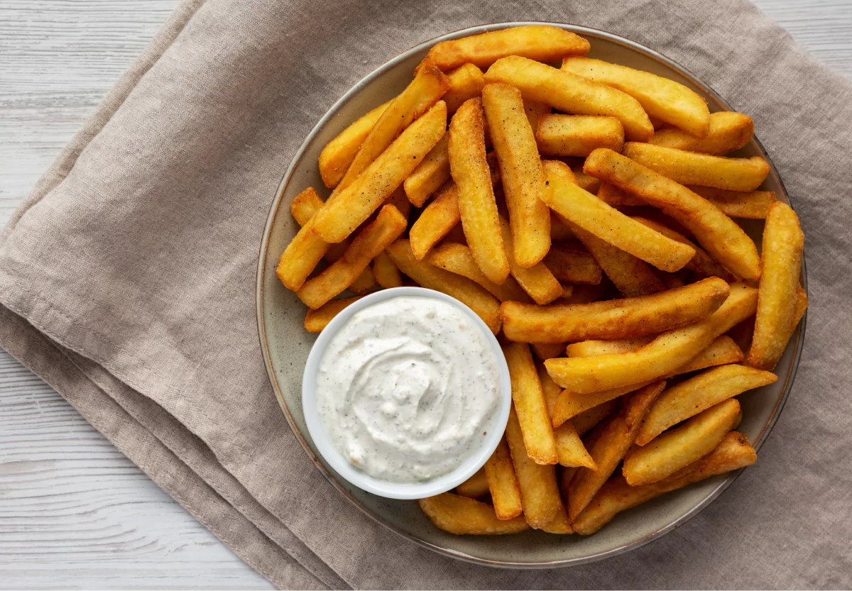 a plate of fries with ranch dressing