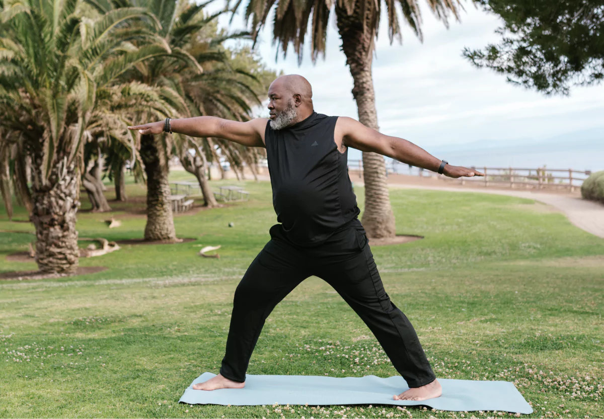 a man doing a yoga pose in the park