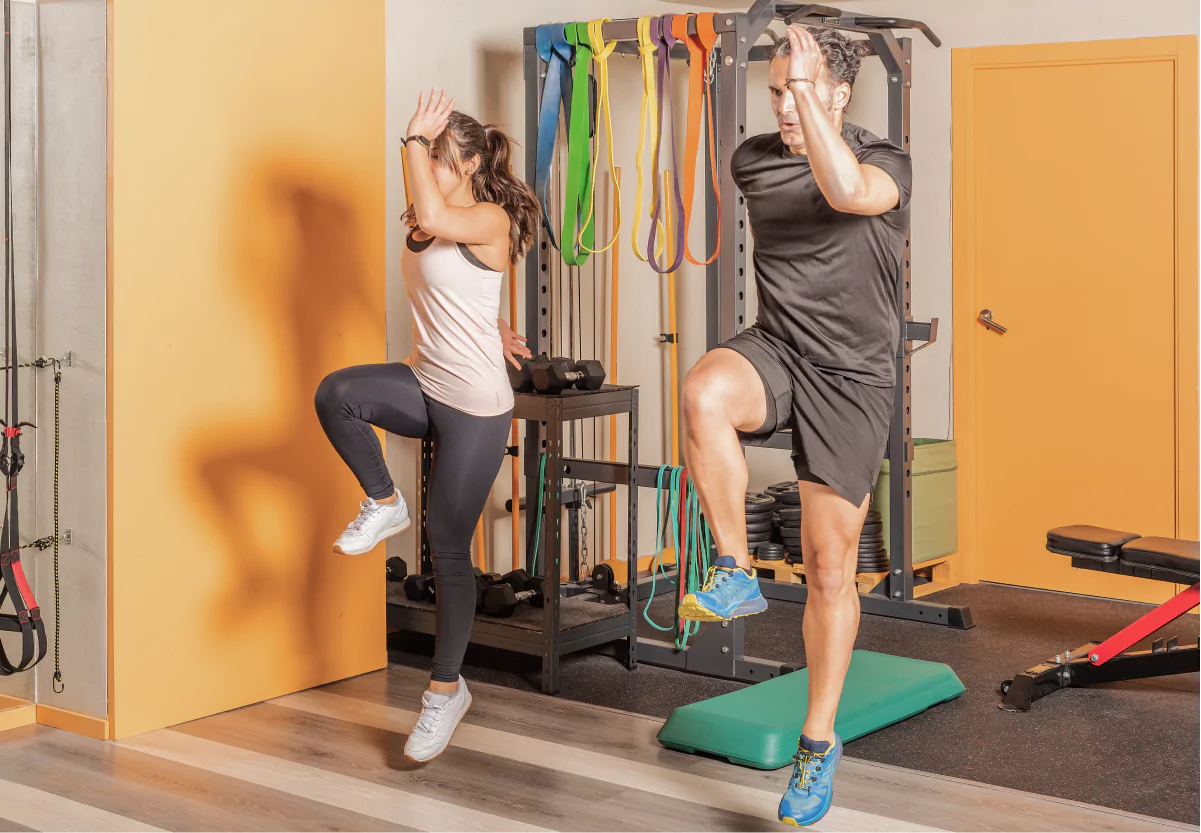 two people doing lunge jumps