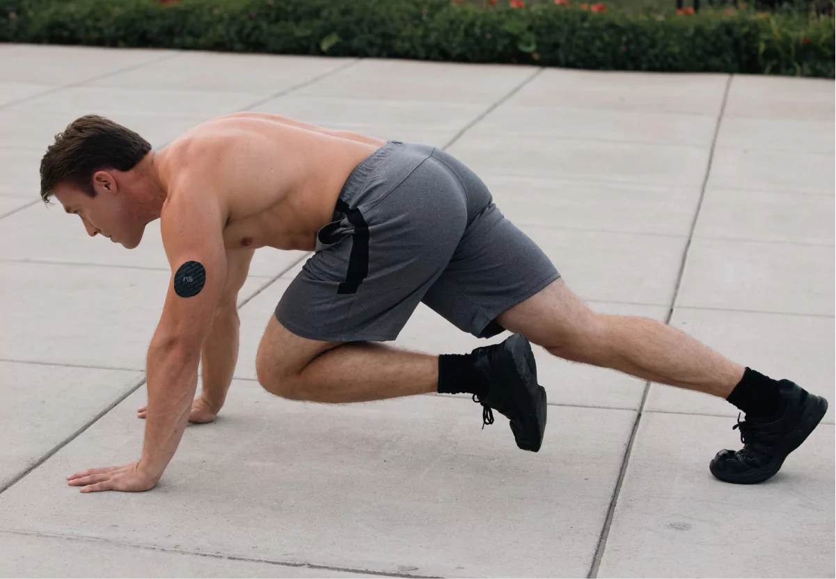 a man with a cgm doing mountain climbers