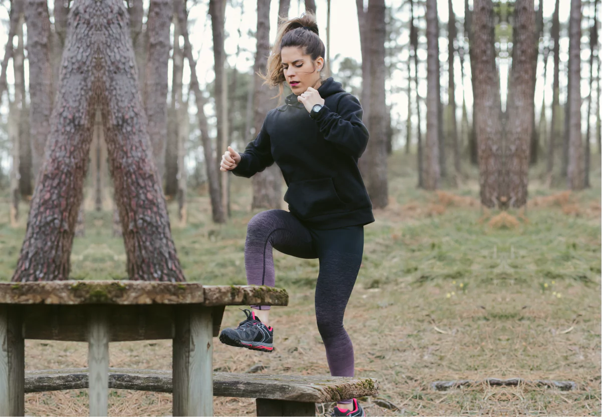 a womn doing toe taps in the forest