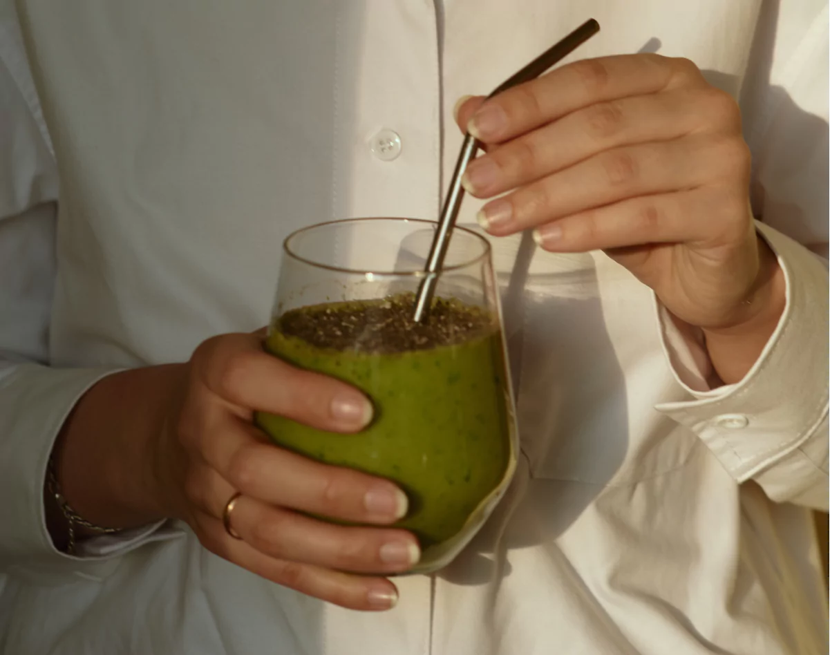 someone drinking a smoothie from a straw