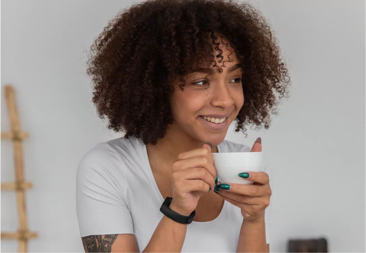 a woman drinking a cup of coffee