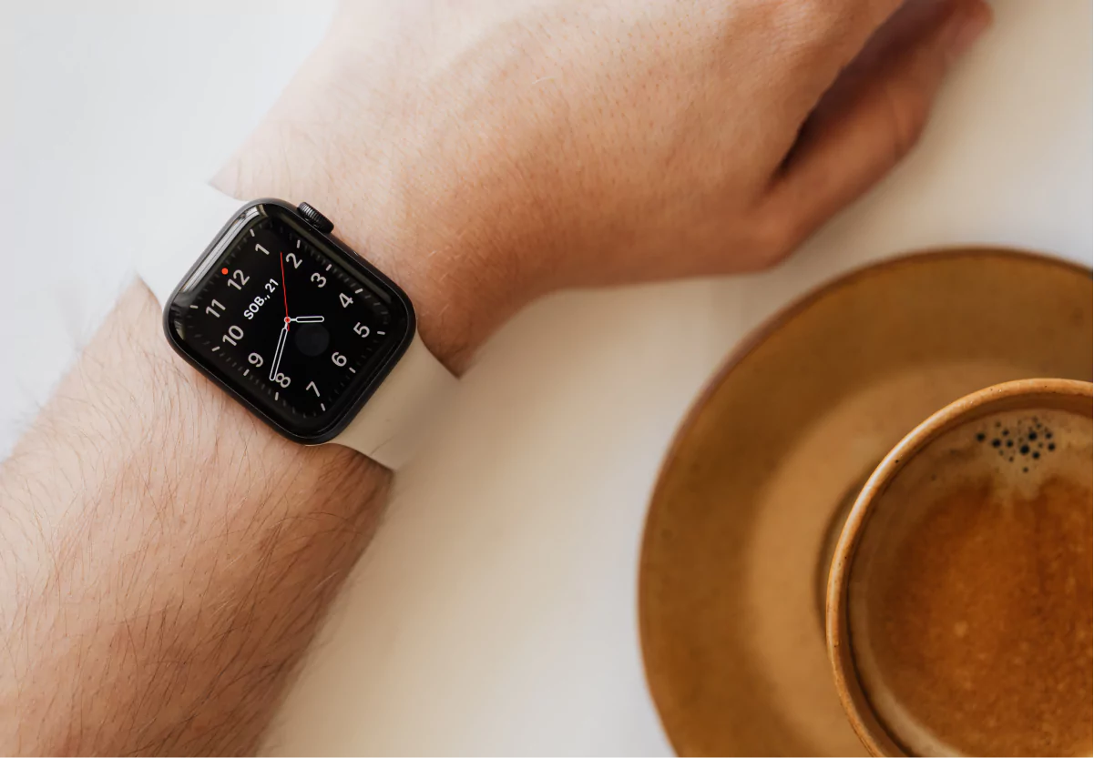 someone with an apple watch and a coffee