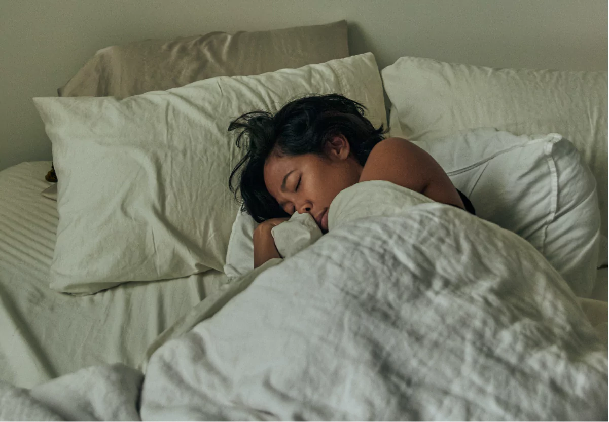 a girl sleeping in bed