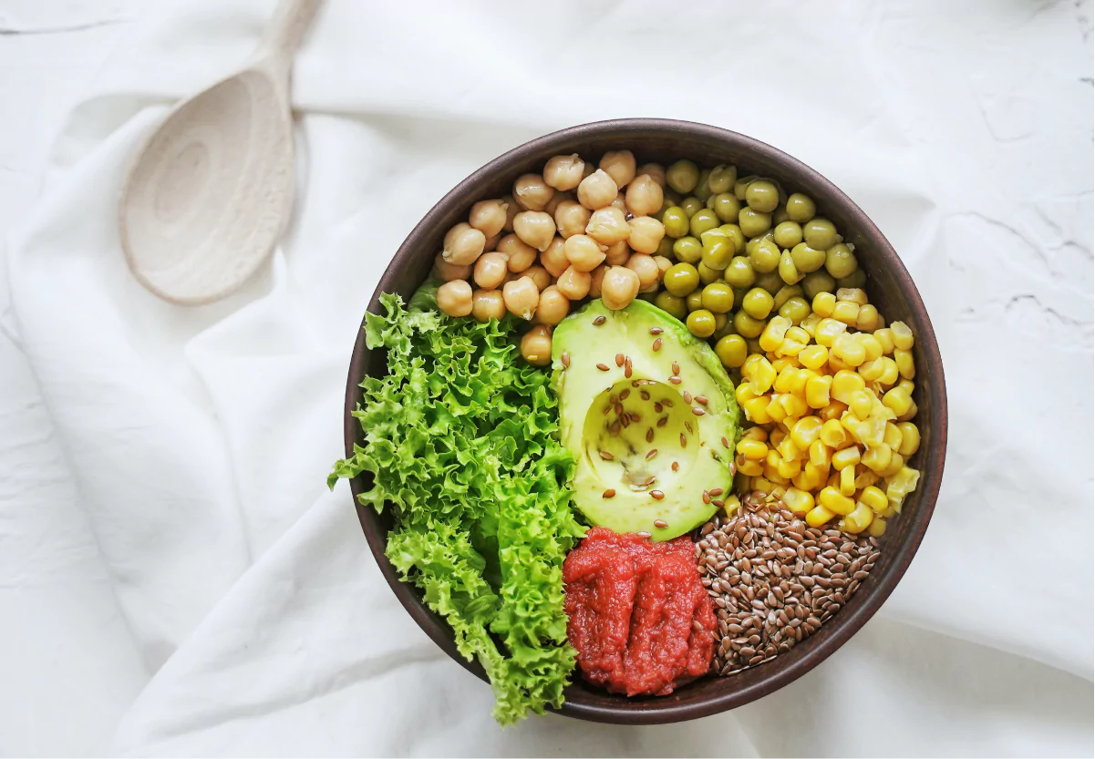 a bowl of chickpeas, avocado, and veggies