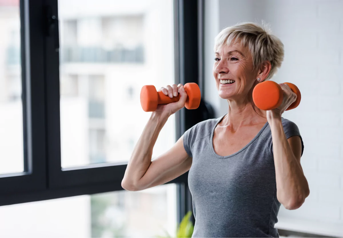 an older woman lifting dumbbells