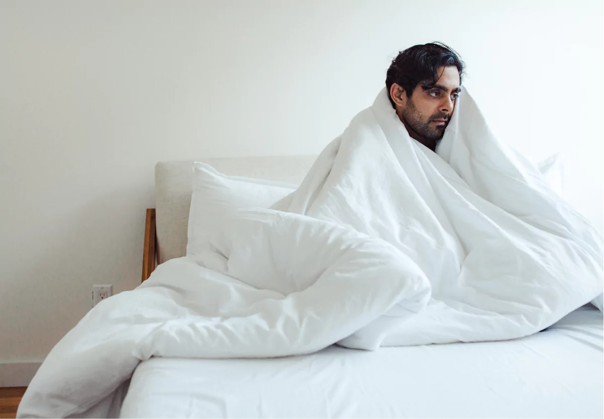 a man in bed looking stressed