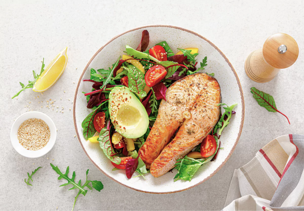 a colorful plate with salmon and greens