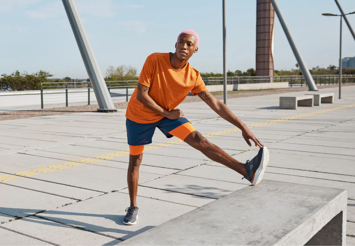 a man in an orange shirt stretching