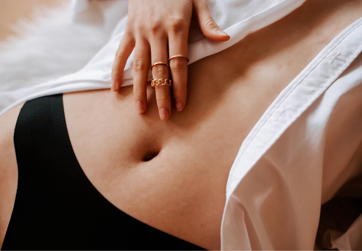 a woman touching her stomach