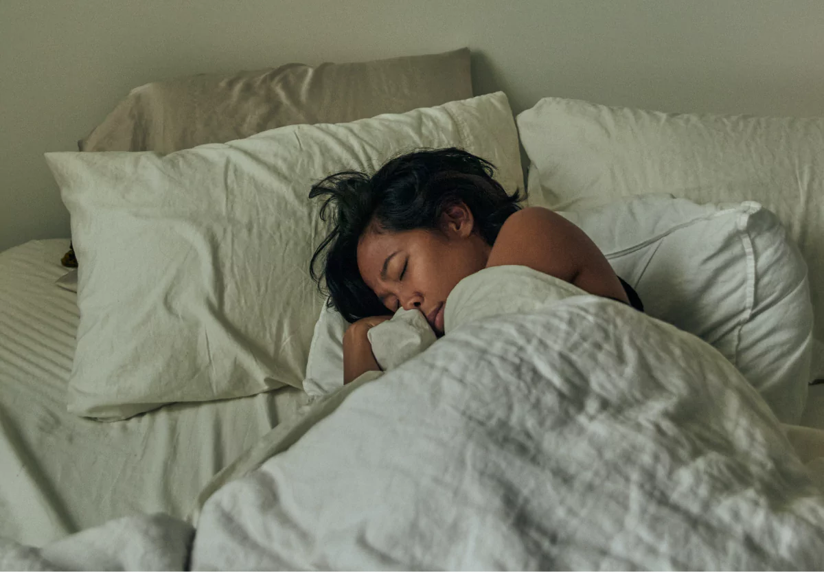 a woman laying in bed asleep