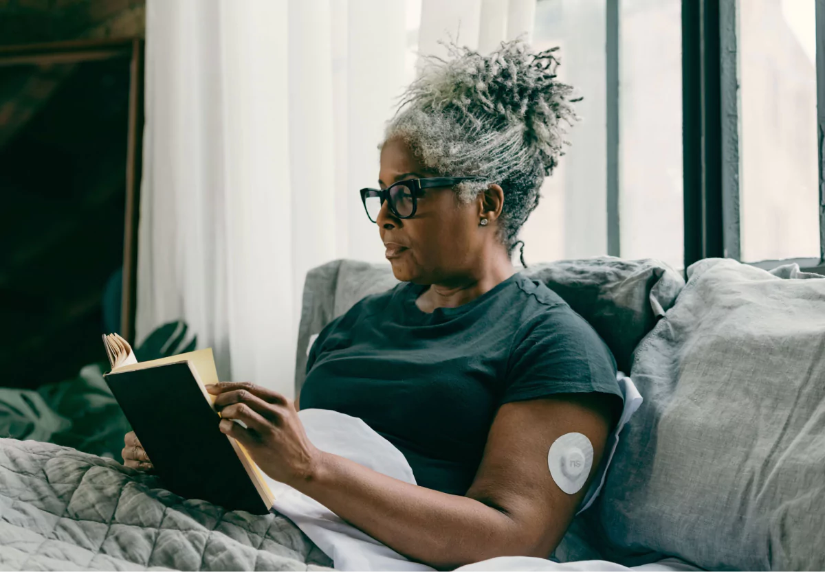 a woman with a cgm reading a book