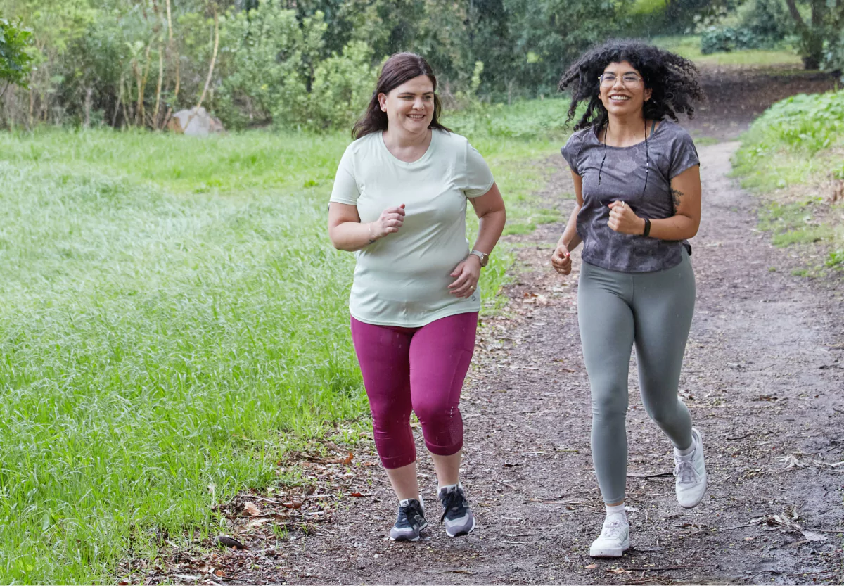 two woman reverse walking in the park