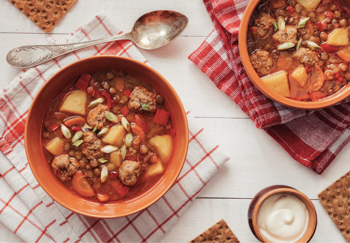 a plate of beans and meatballs in a soup