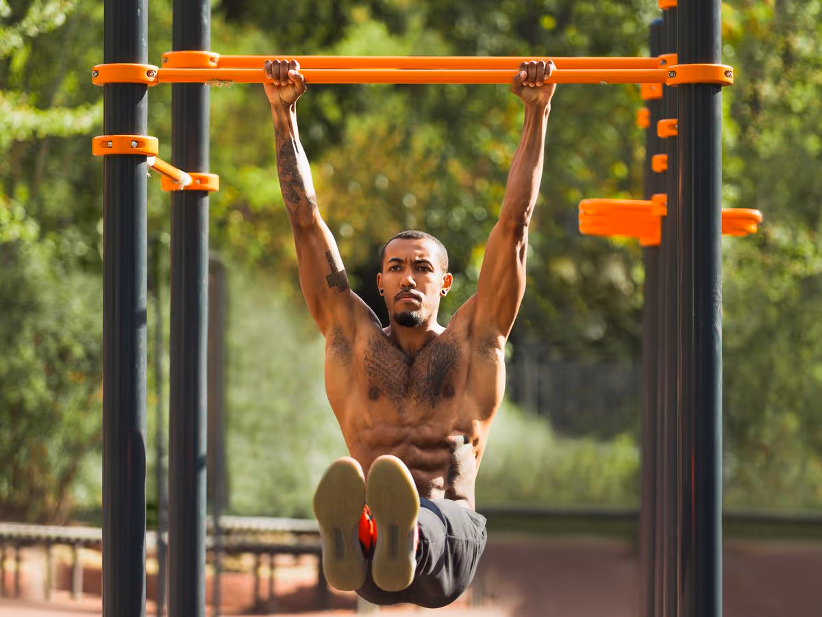 a man doing a hanging knee raise