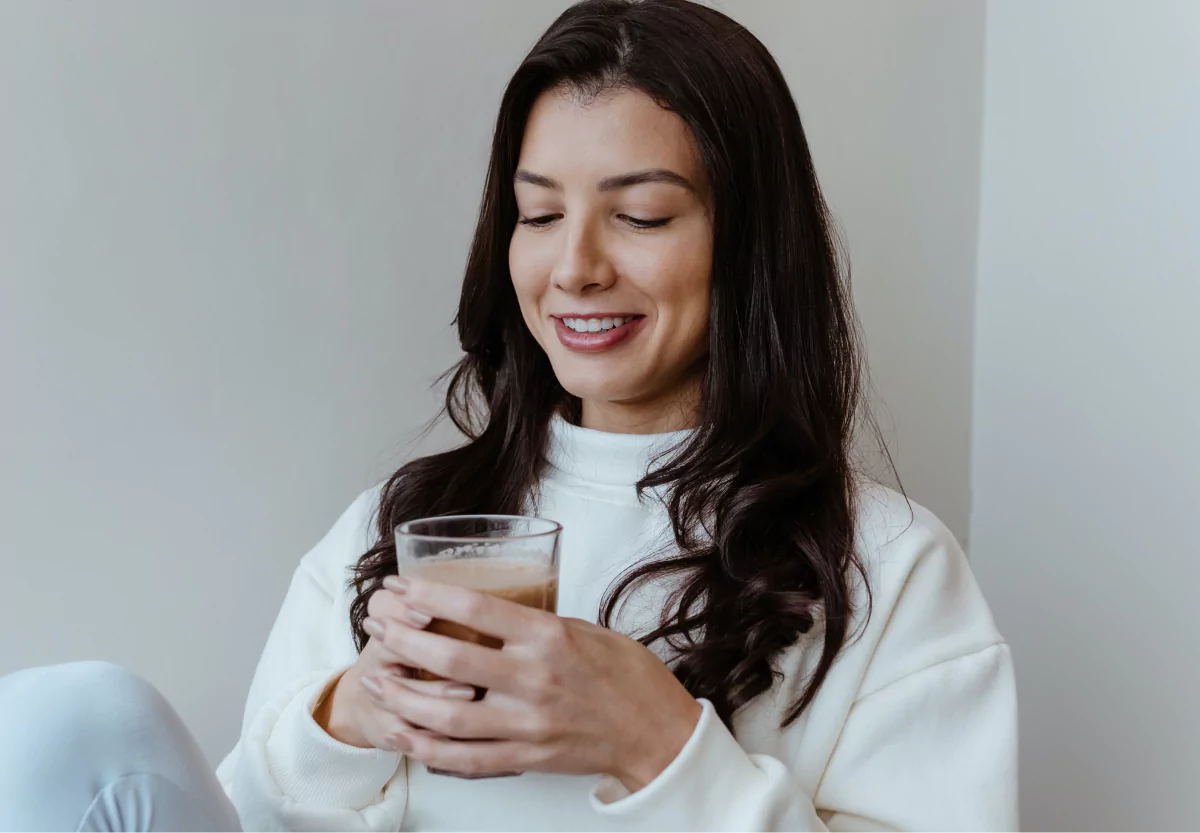 a woman holding a weight loss shake